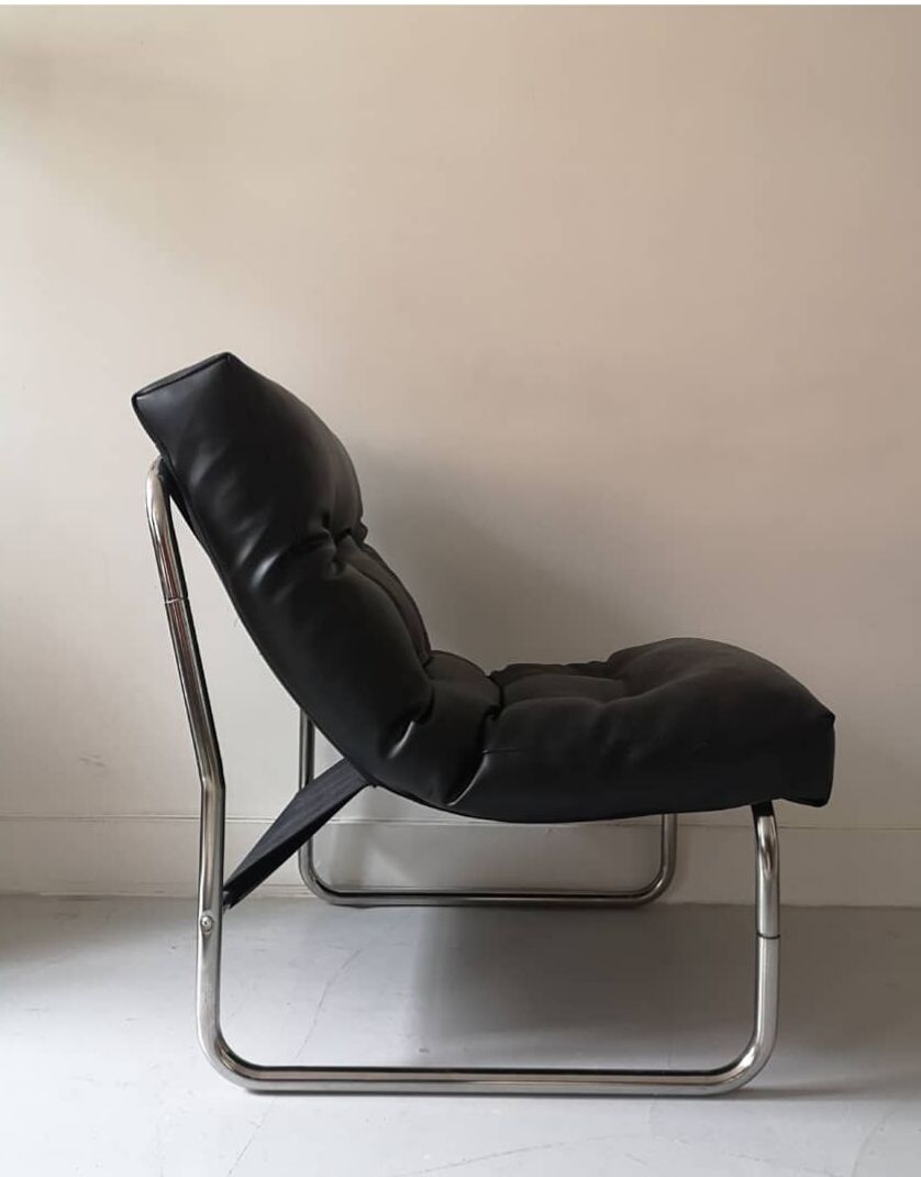 Tubular fireside chair in black skai and metal, design 1970