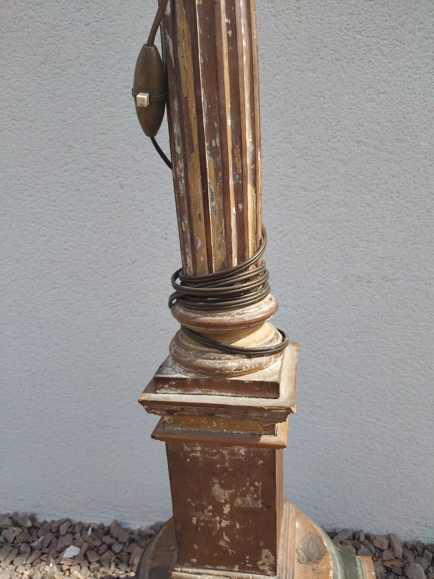 Large antique church candlestick in carved wood transformed into a lamp.