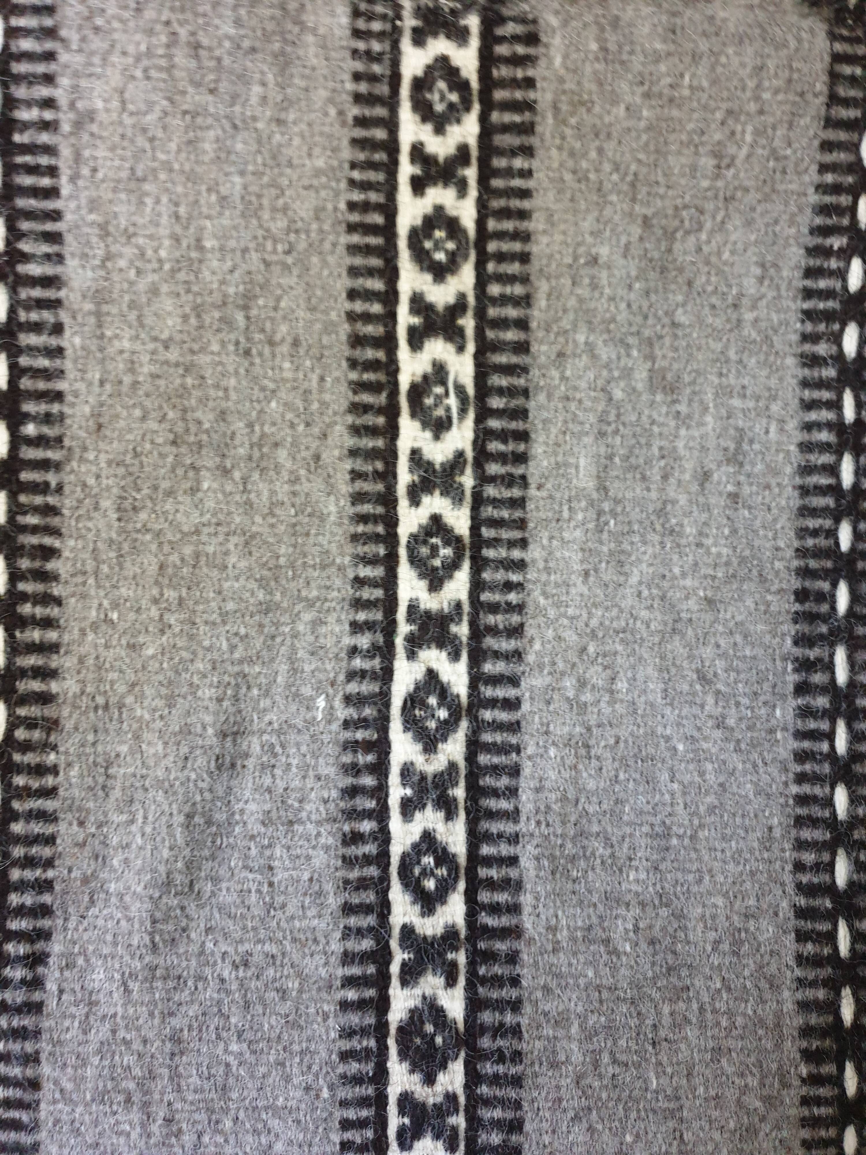 Handwoven vintage geometrical rug, grey background