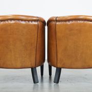 Set of 2 sheep leather club chairs finished with black piping