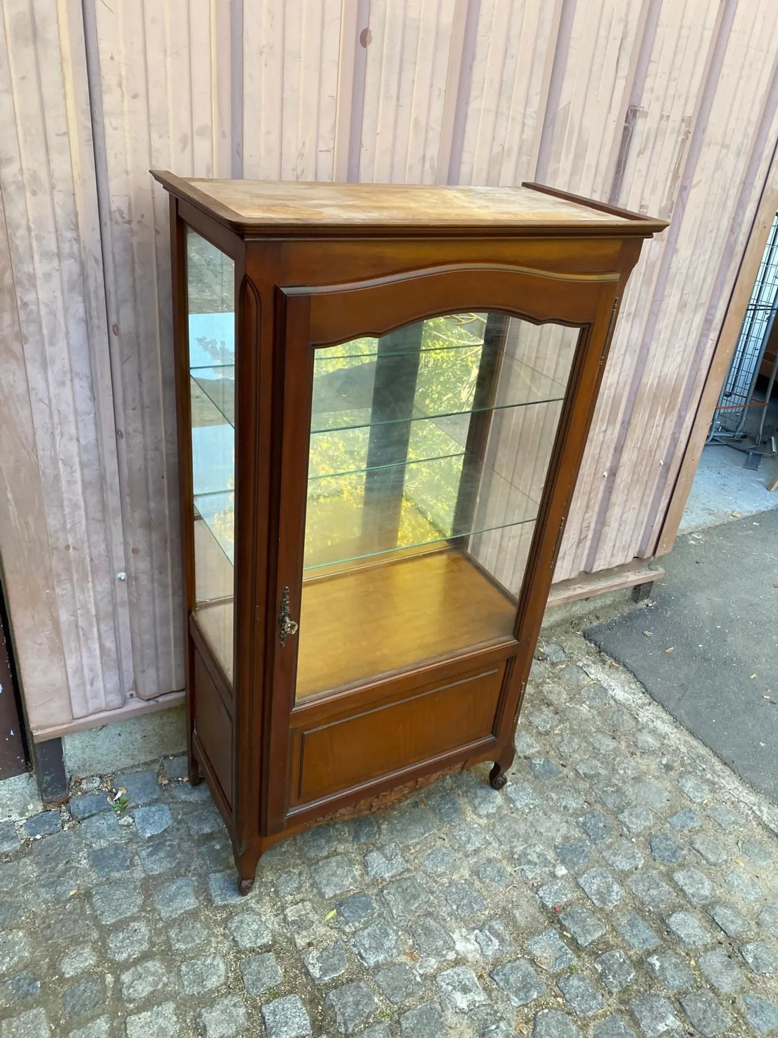 Louis XV style display cabinet in cherry wood with a mirrored back and glass shelves.
