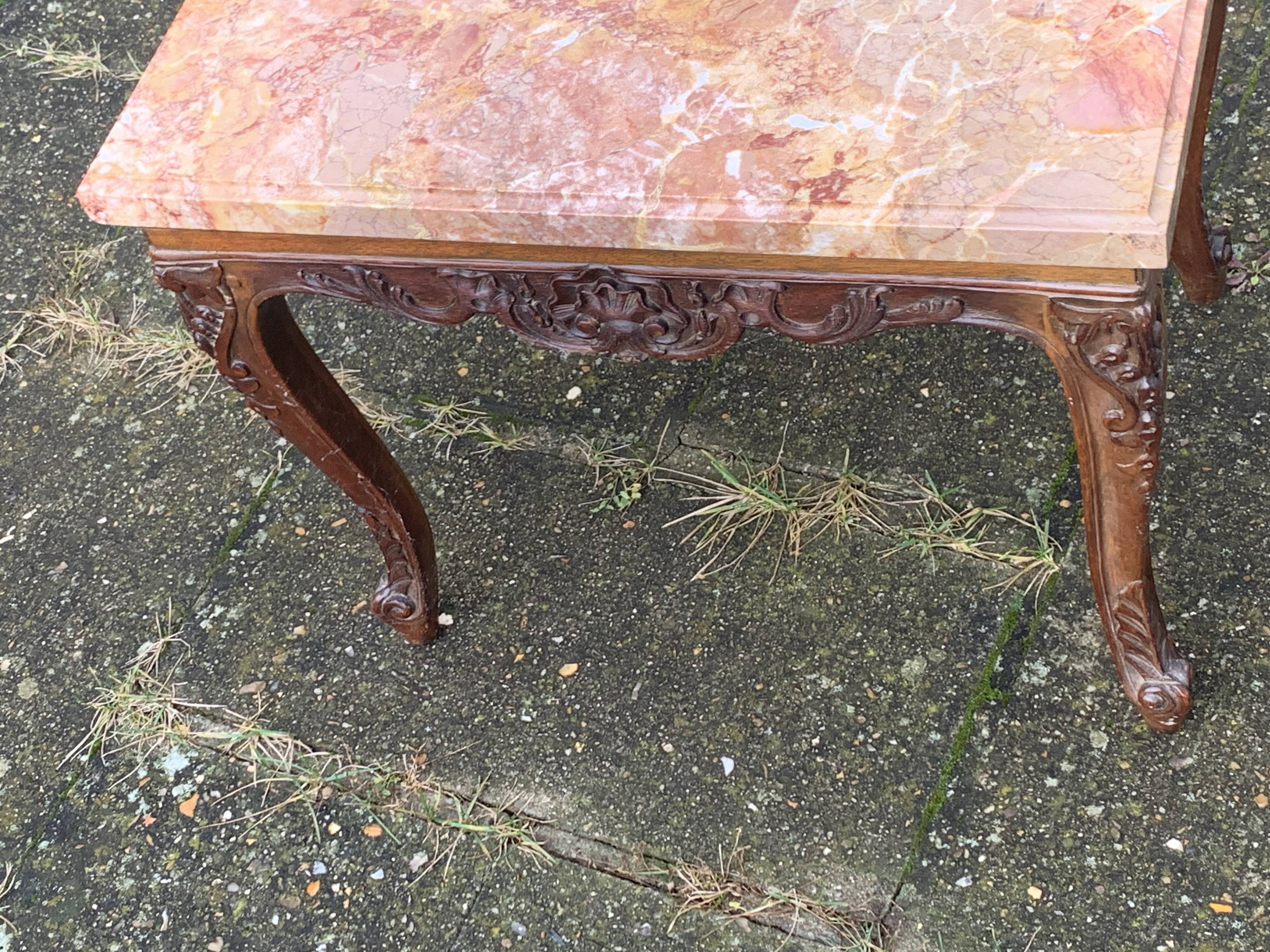 Carved wooden coffee table with shell pattern and removable pink marble top, old
