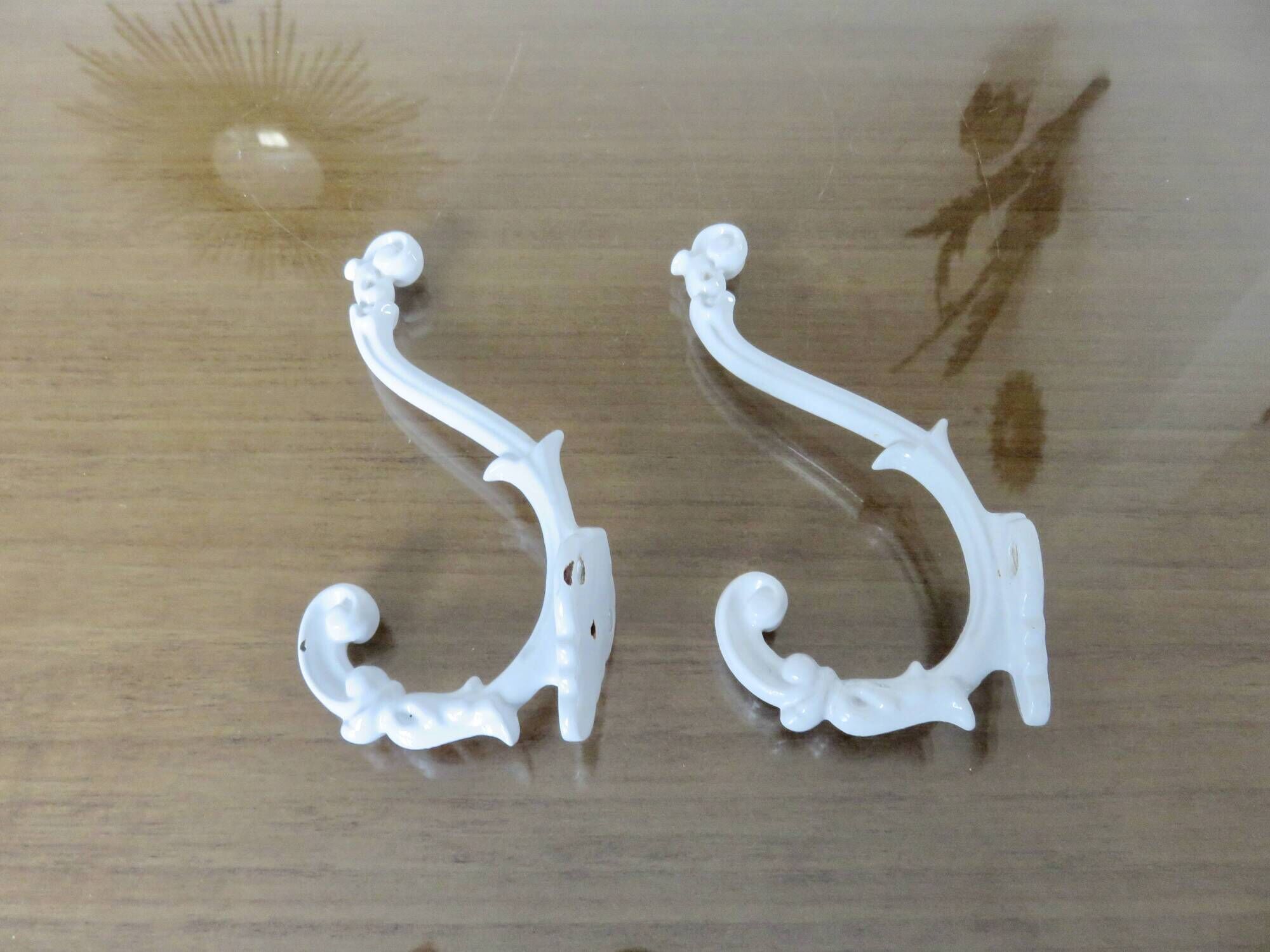 Pair of Art Deco white cast iron coat hooks from the 1930s and 1940s