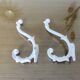 Pair of Art Deco white cast iron coat hooks from the 1930s and 1940s