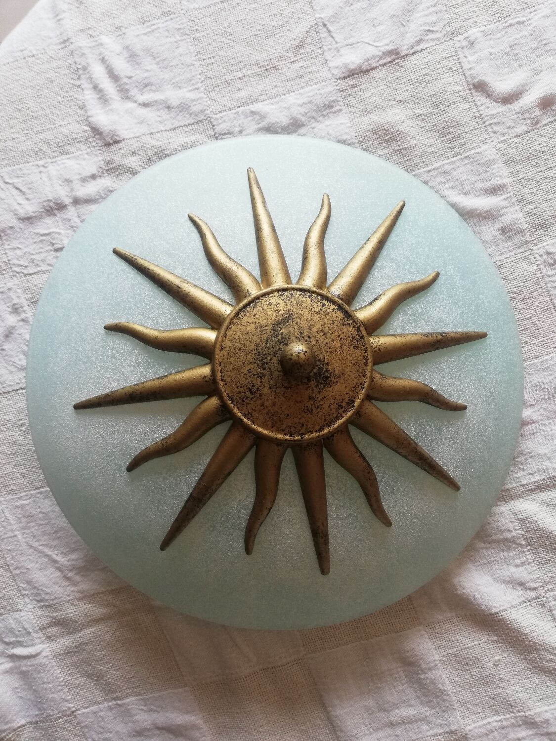 White opaque glass ceiling light and golden metal sun