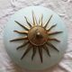 White opaque glass ceiling light and golden metal sun