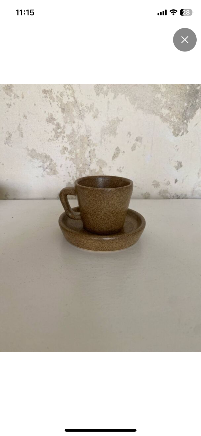 Set of stoneware coffee cups with saucers.
