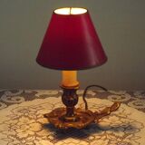 Vintage French bronze Wee Willie Winkie style lamp with red card shade.