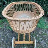 Vintage wicker cradle on casters