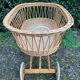 Vintage wicker cradle on casters