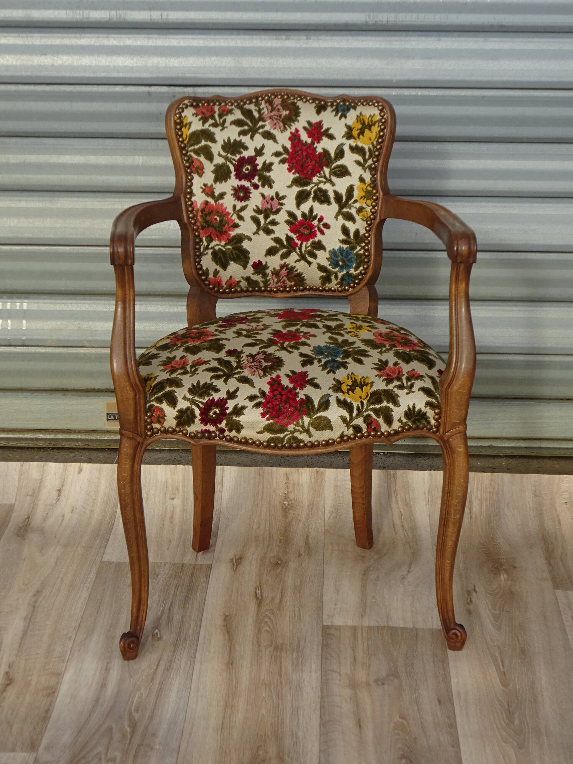 Convertible armchair with brocade fabric and floral patterns.