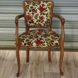 Convertible armchair with brocade fabric and floral patterns.