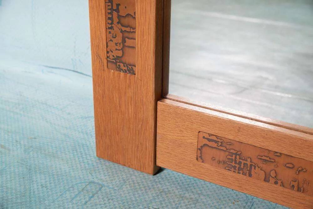 Vintage Danish wall mirror design from the 1960s in oak and stamped brass.