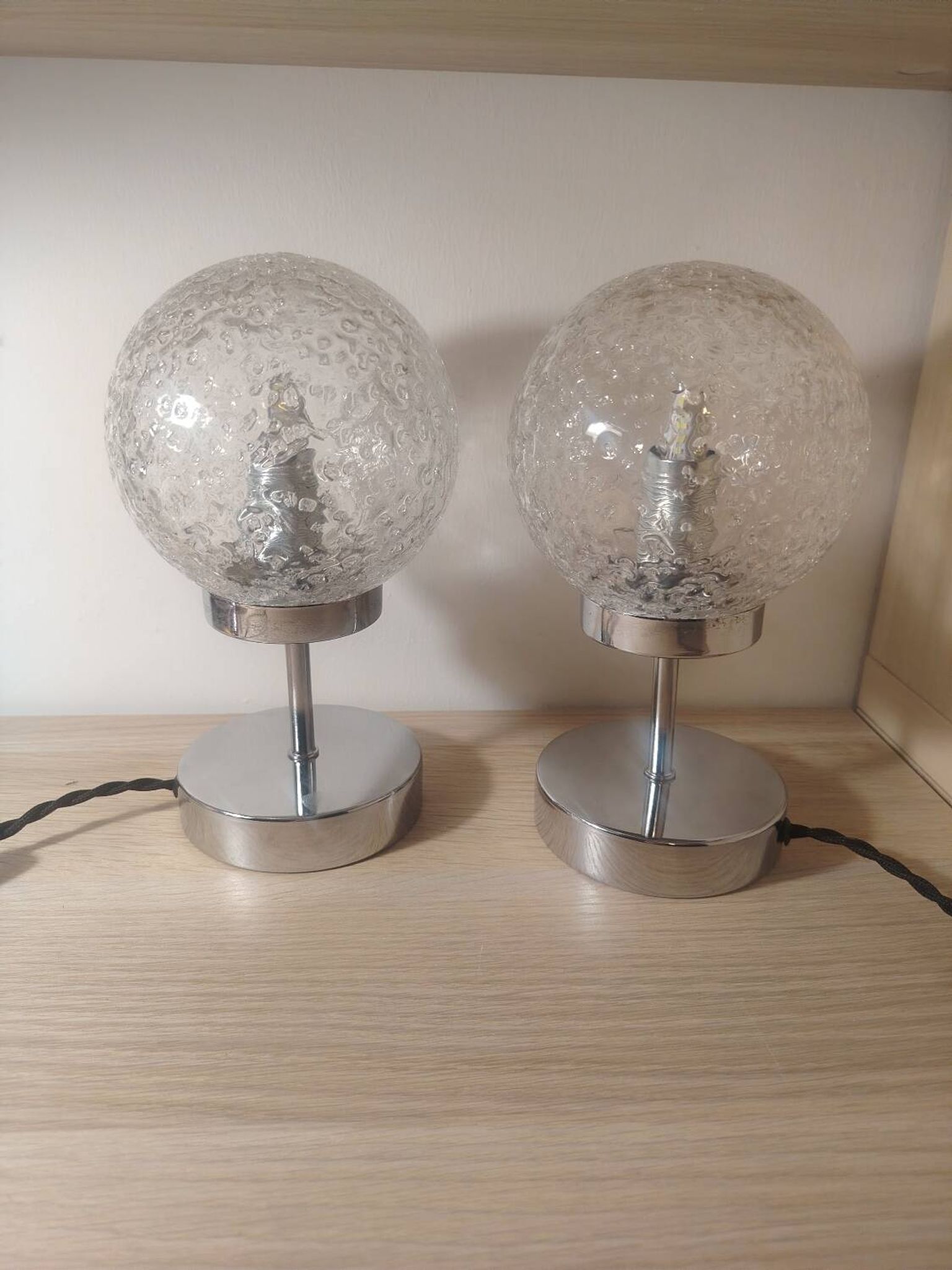Duo of textured globe lamps with a large play of light.