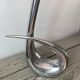 Sculptural vase design in polished aluminium.