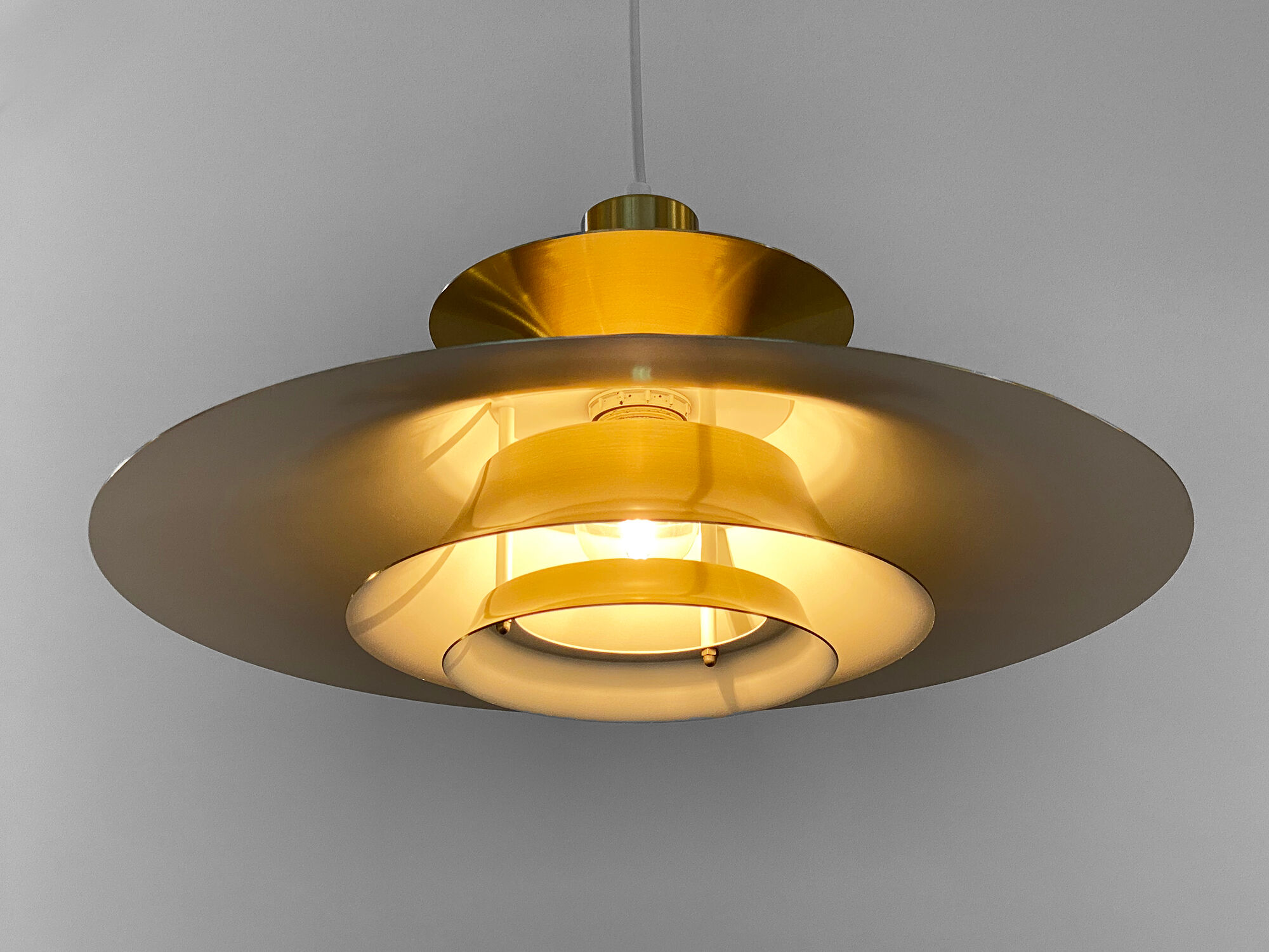 Golden colored aluminum pendant light from Frandsen Lighting. Denmark 1970s