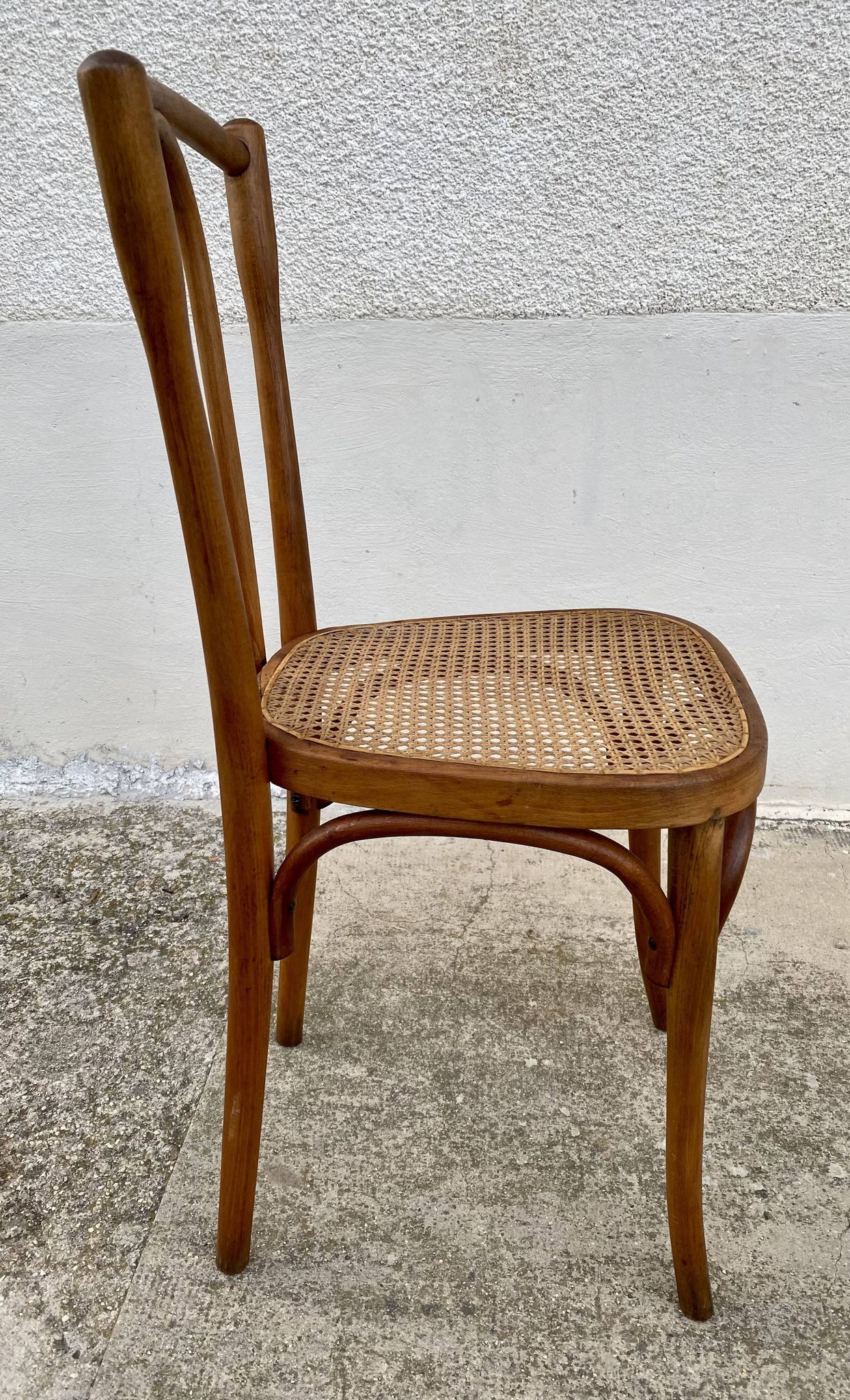19th-century bistro chair, signed, with caned seat.