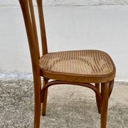 19th-century bistro chair, signed, with caned seat.