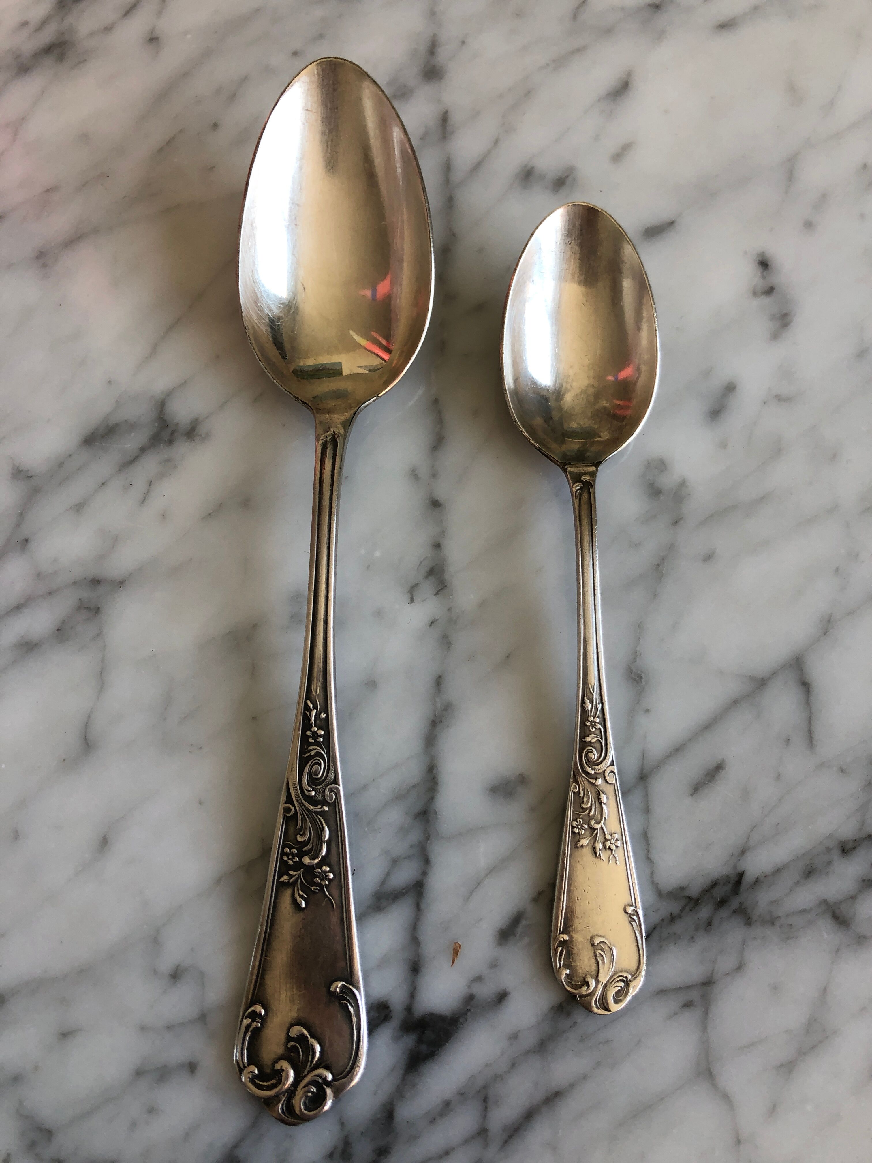 Duo of silver metal spoons