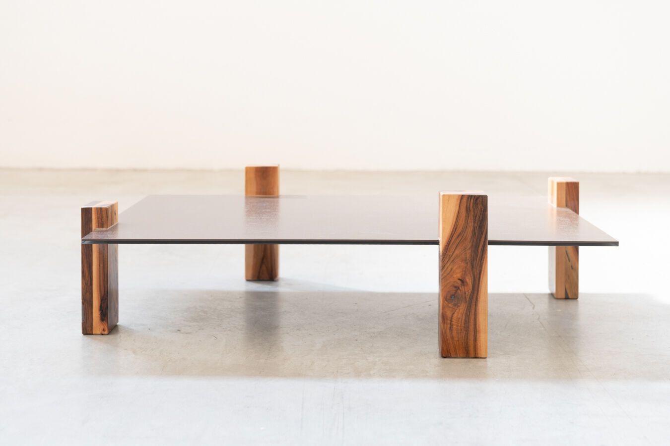 Handcrafted coffee table with ceramic glass top and walnut legs