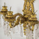 Two bronze and cut glass wall-mounted chandeliers