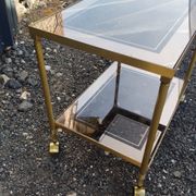 Vintage golden metal rolling dessert trolley