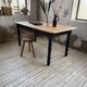 Oak farmhouse table with turned black legs.