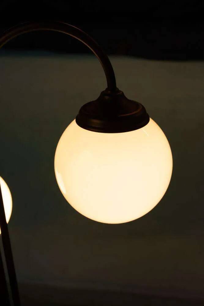 Minimalist floor lamp in glass, space age style.