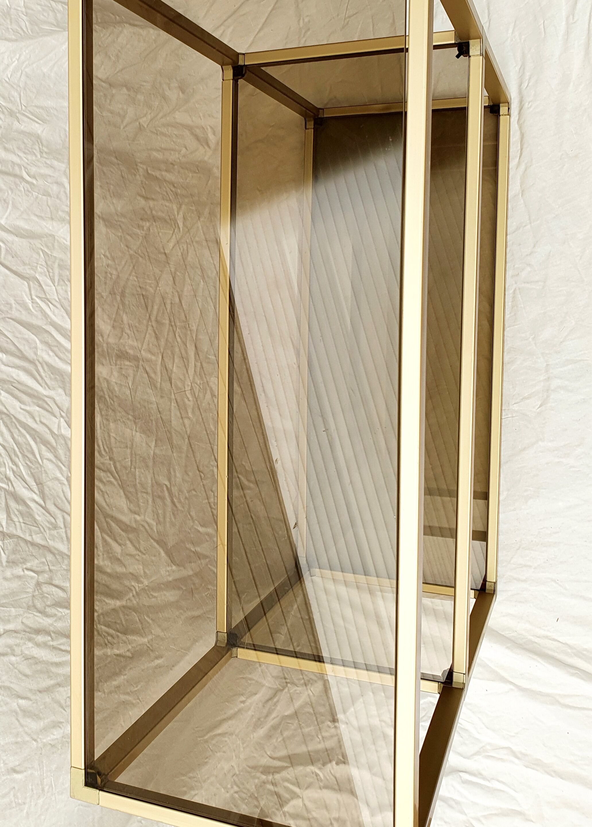 Golden metal shelf and smoked glass