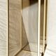 Golden metal shelf and smoked glass