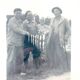 Fishing trophy with radiant faces, c. 1950. Black and white photograph.