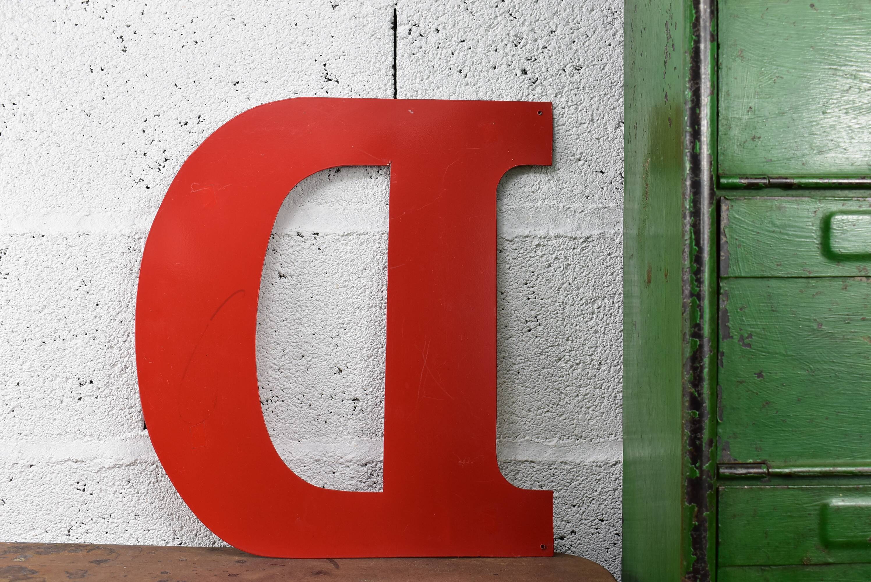 industrial letter "D" in red metal
