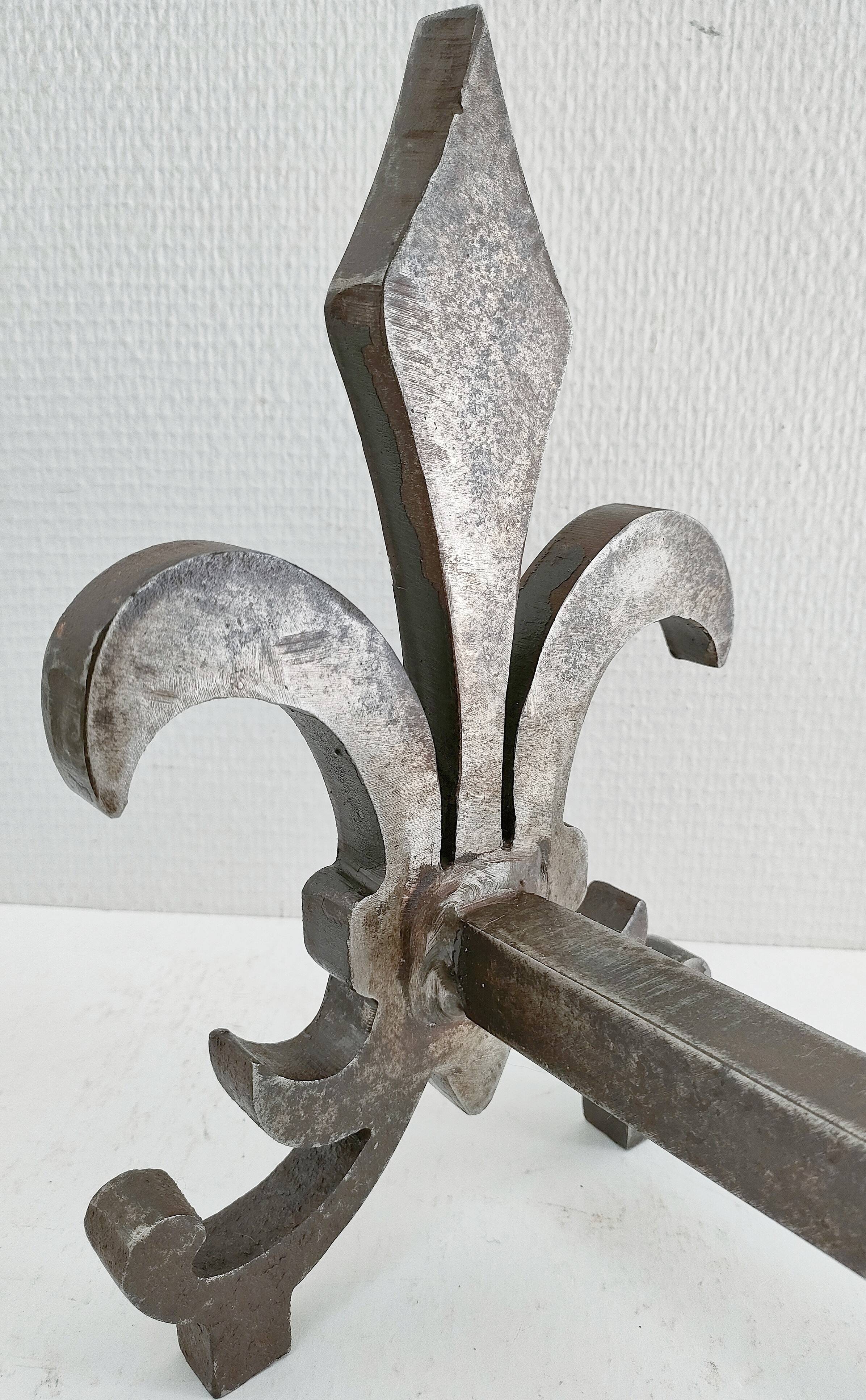 Pair of vintage steel fleur-de-lys andirons