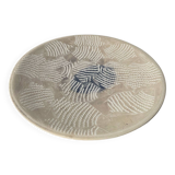 Round ethnic handmade fish dish