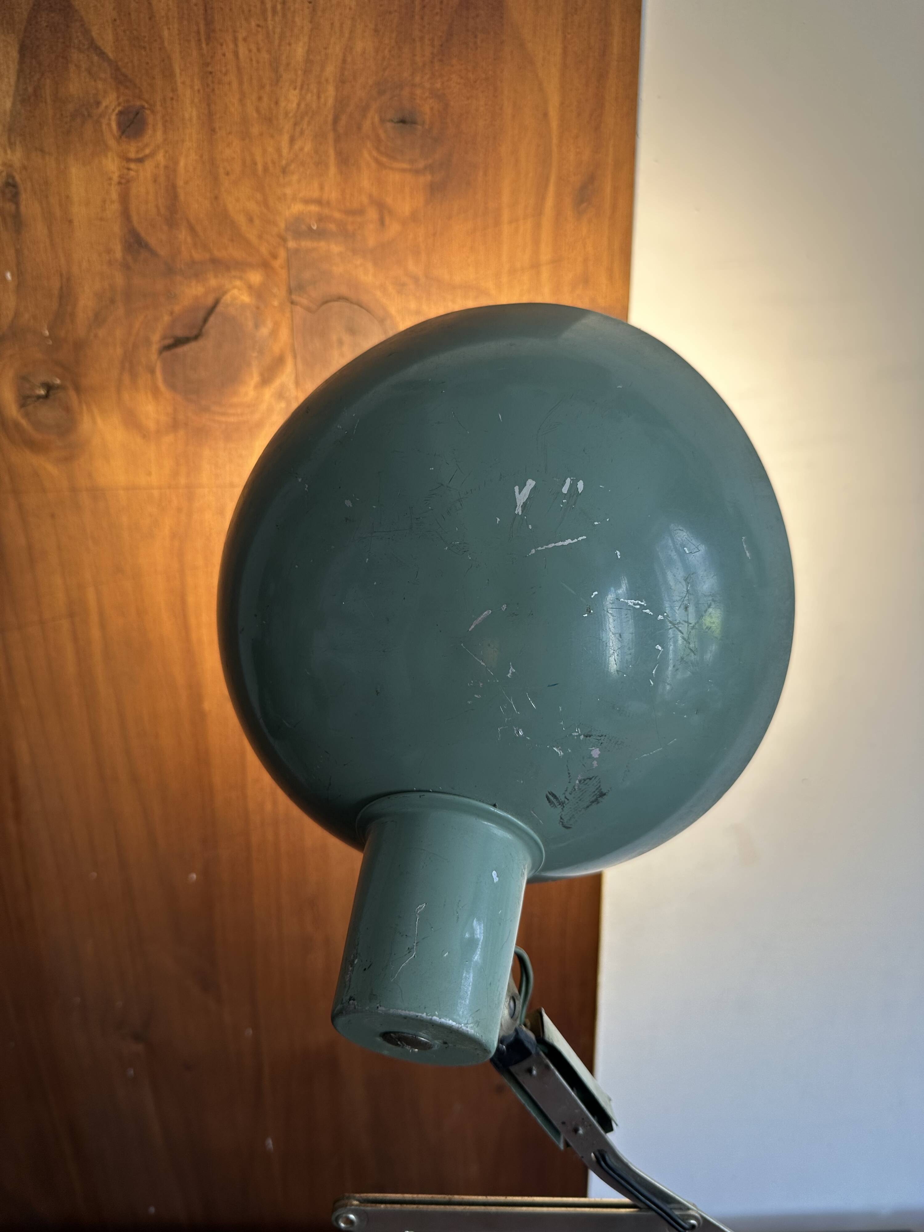 Old extendable accordion lamp in celadon green, workshop spirit.
