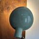Old extendable accordion lamp in celadon green, workshop spirit.