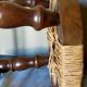 Low vintage regional stool in solid wood with straw top