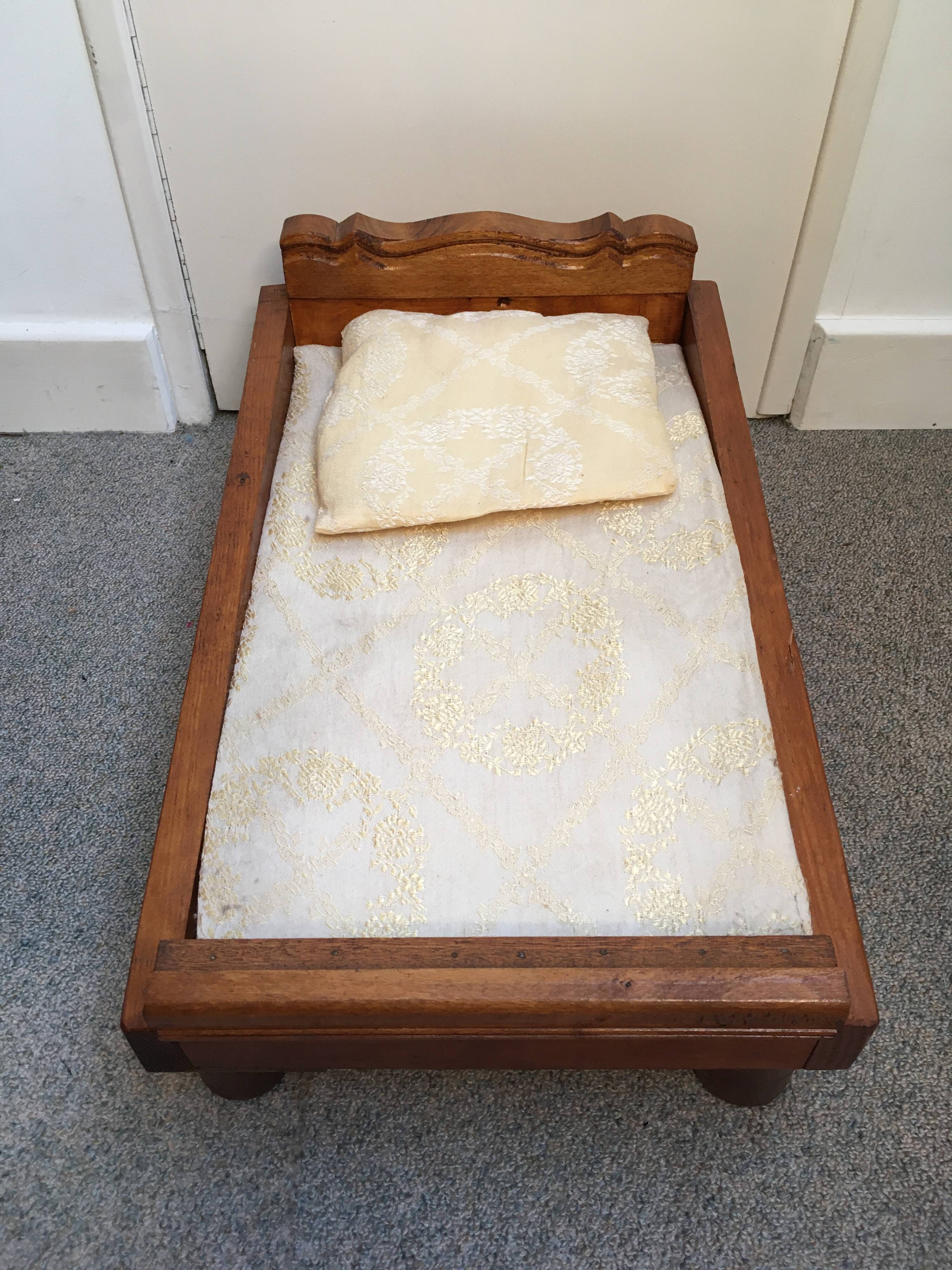 Old wooden bed for doll with mattress and pillow