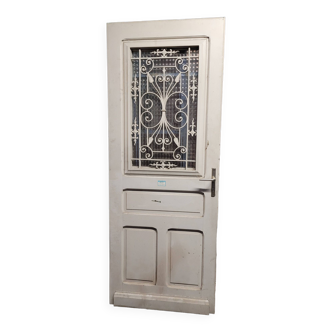 Old oak front door with cast iron grille