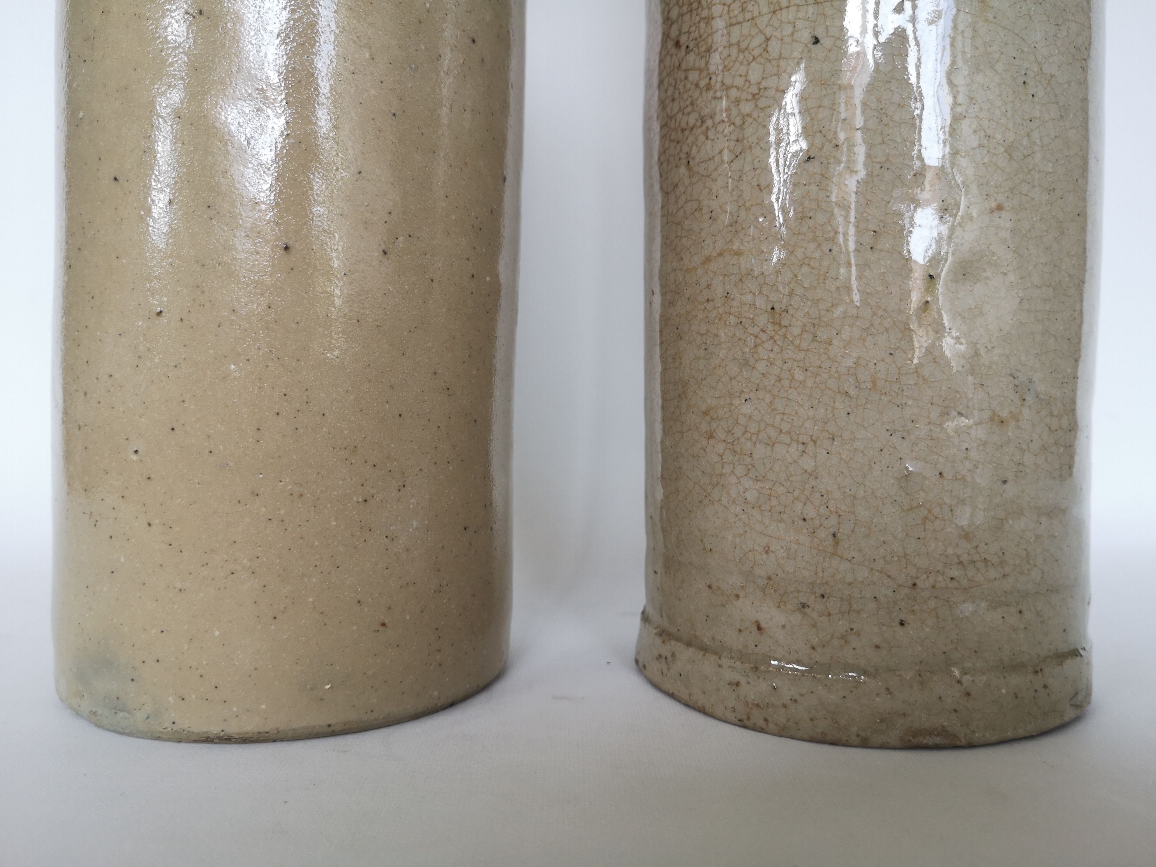Pair of enamelled sandstone bottles