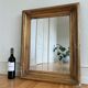 Antique giltwood wall mirror in gold