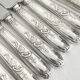 12 antique silver-plated knives with acanthus shell decoration and stainless steel blades.
