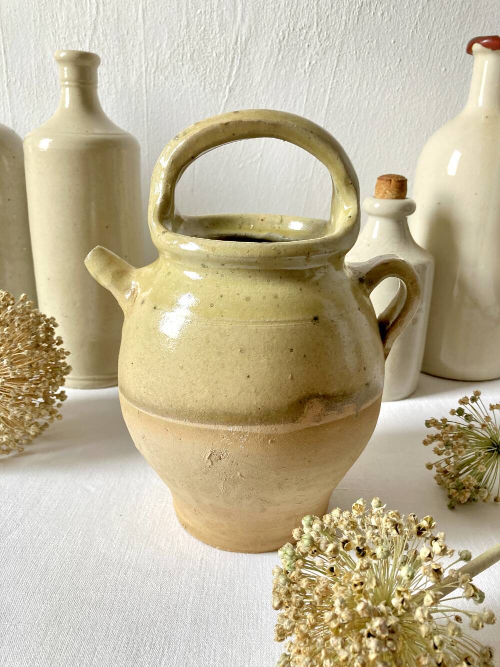 Old small goat-shaped jug in ochre glazed stoneware.