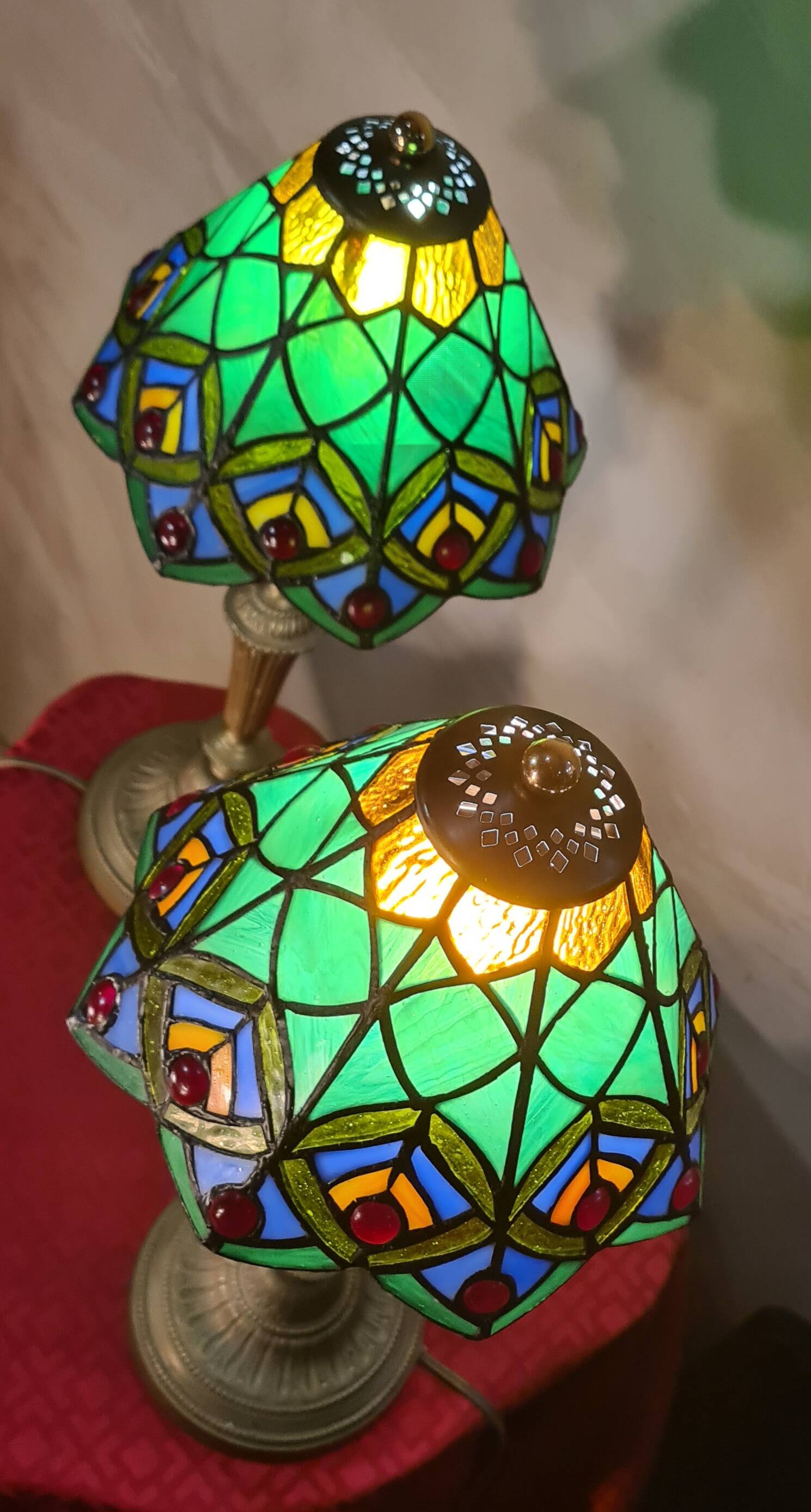 Pair of art nouveau bronze lamps, Tiffany-style glass lampshades