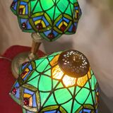 Pair of art nouveau bronze lamps, Tiffany-style glass lampshades