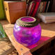 Antique iridescent purple glass lantern with a brass frame.