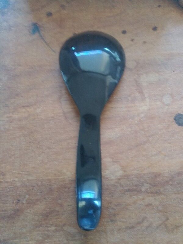 Rice spoon covered with serving in Asian handicraft horn