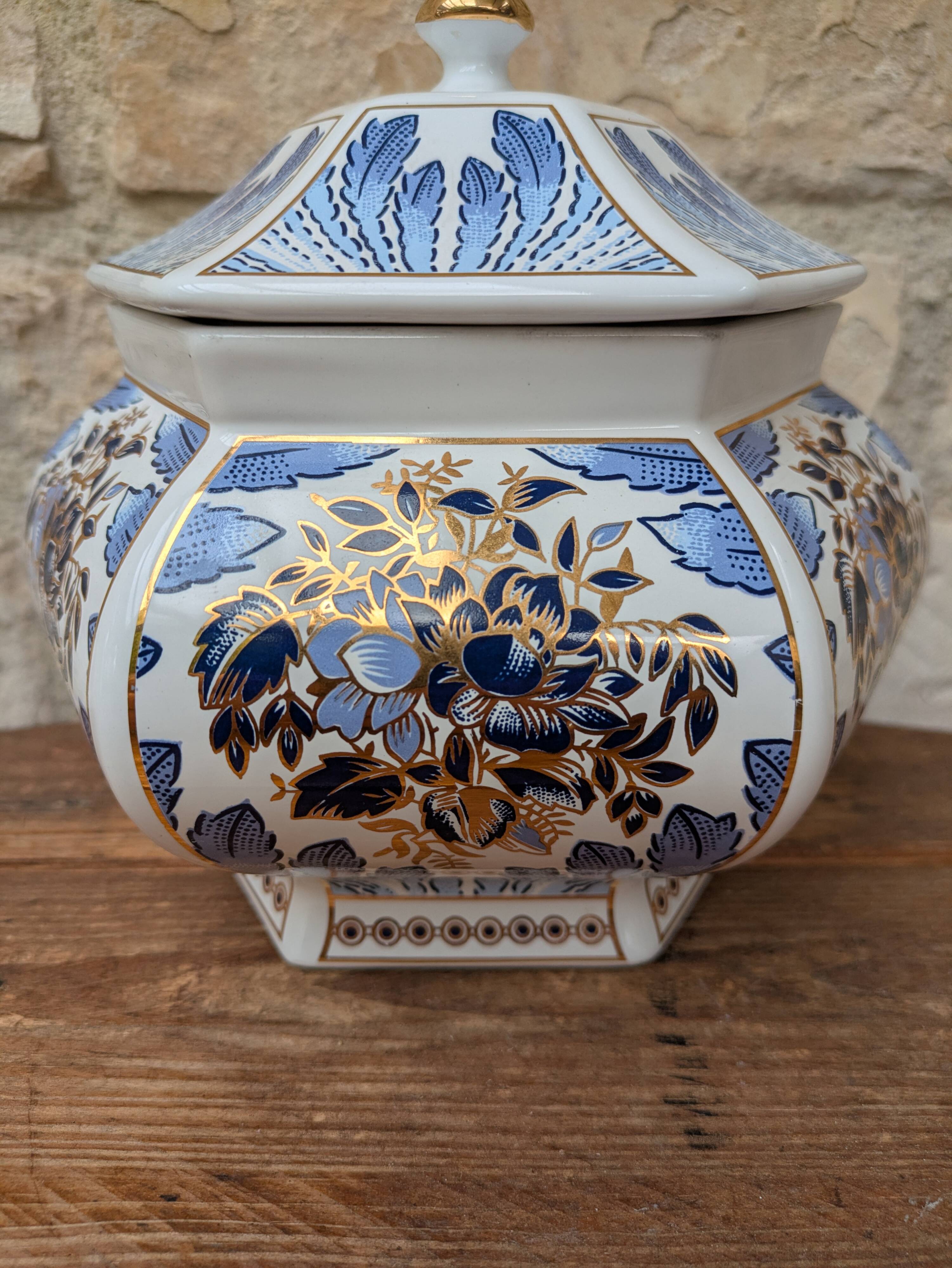 Decorative pot jar with a lid featuring a blue floral pattern and gilding.