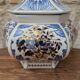 Decorative pot jar with a lid featuring a blue floral pattern and gilding.