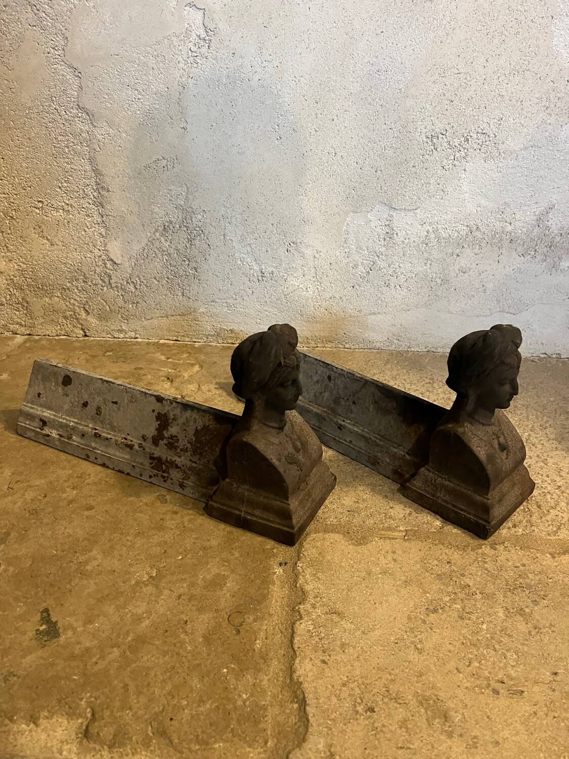 Pair of cast iron andirons with face